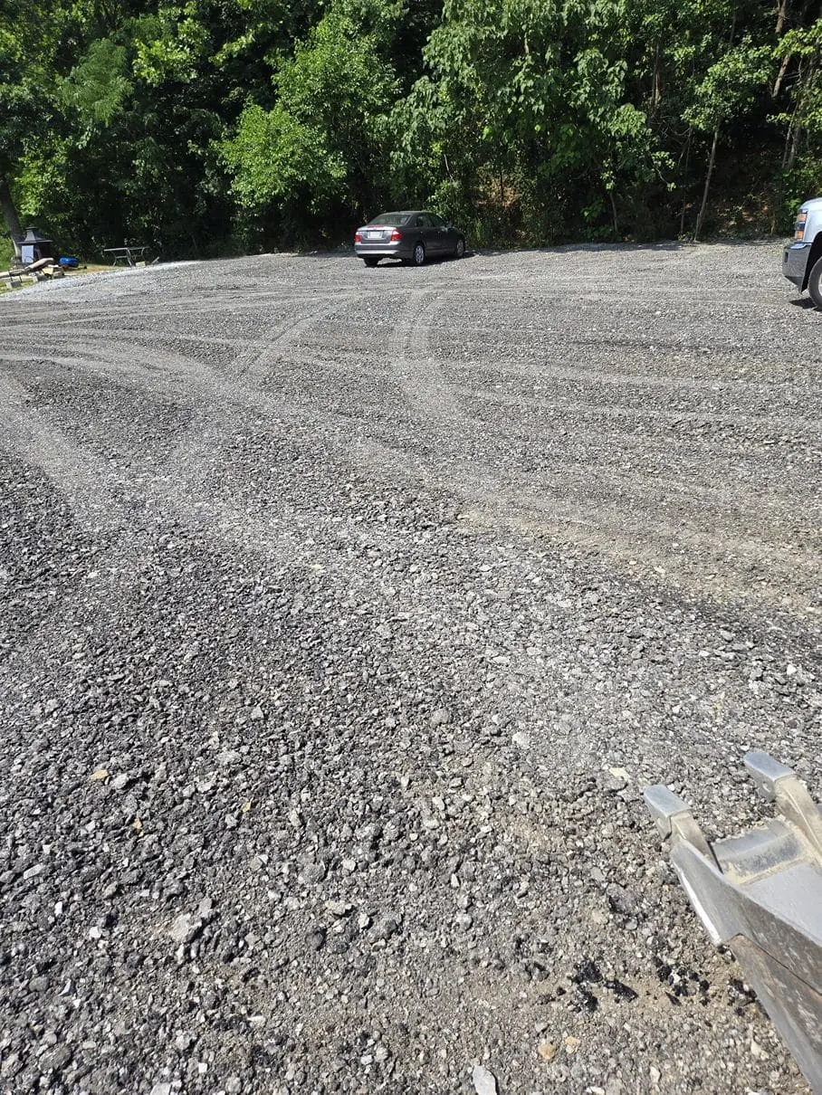 Smooth fresh asphalt walkway winding through a tree-lined residential property